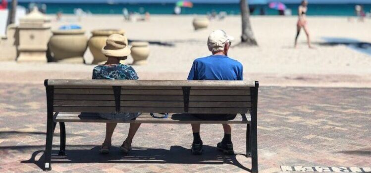 An elderly couple sitting on a bench in one of the best places in South Florida for families