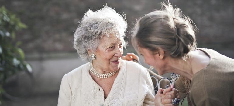 two elderly women talking about making moving easier for seniors