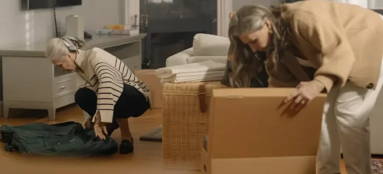Two women packing and thinking about how to make moving easier for seniors